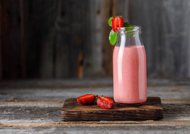 Strawberry milkshake in the glass jar. Strawberry smoothie, healthy food for breakfast and snack Strawberry milkshake in the glass jar. Strawberry smoothie, healthy food for breakfast and snack strawberry smoothie stock pictures, royalty-free photos & images