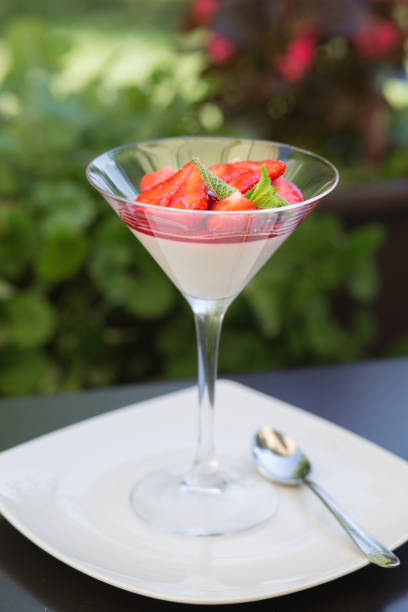 Strawberry panna cota in a martini glass stock photo