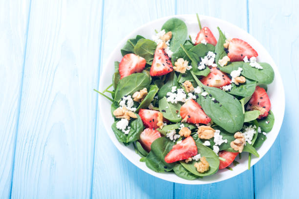 Strawberry salad with spinach , cheese and walnut . Healthy food stock photo