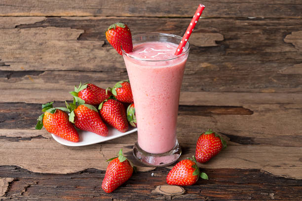 Strawberry smoothies juice Strawberry smoothies juice and strawberry  fruit for for milkshake on wooden background. strawberry smoothie stock pictures, royalty-free photos & images