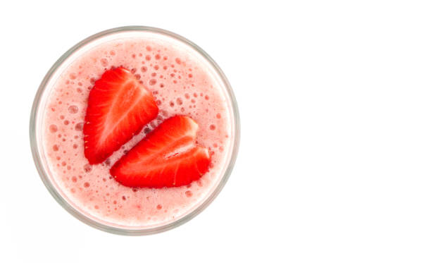 Strawberry smoothy in a glass, isolated on white background. Red berry healthy shake. Natural shade. Strawberry smoothy in a glass, isolated on white background. Red berry healthy shake. Natural shade. strawberry smoothie stock pictures, royalty-free photos & images
