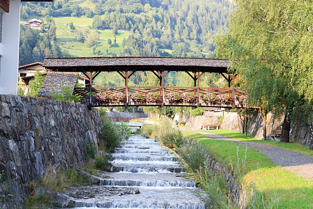 Stream Bretterwandbach with bridge in Matrei in Osttirol, Austria Stream Bretterwandbach with bridge in Matrei in Osttirol, Austria osttirol stock pictures, royalty-free photos & images