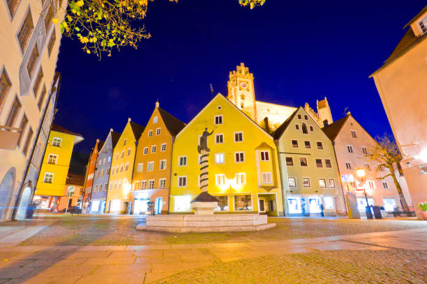 Street cafe in the Fussen old town city center. Fussen is a small town in Bavaria, Germany. Fussen, Germany old townscape at night. lech river stock pictures, royalty-free photos & images