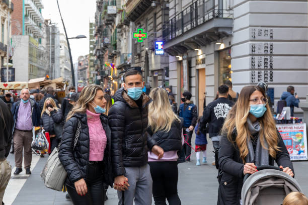 Street crowded with people with protective masks, in Naples, Italy. stock photo