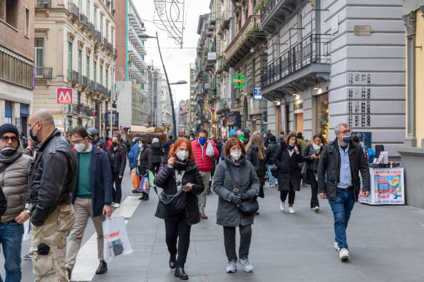 Street crowded with people with protective masks, in Naples, Italy. stock photo