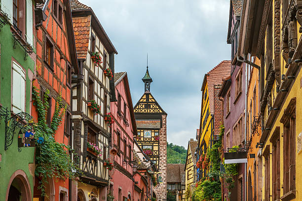 street in Riquewihr, Alsace, France Main street with historical houses in Riquewihr, Alsace, France riquewihr stock pictures, royalty-free photos & images