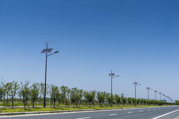 Street lamp powered by solar and wind power Street lamp powered by solar and wind power vertical axis wind turbine stock pictures, royalty-free photos & images