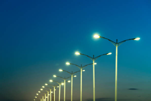 street lamps under blue sky at dusk stock photo