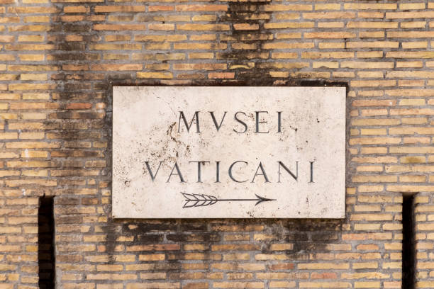 Street name Musei Vaticani - Engl: vatican museum -  painted at the wall in Rome stock photo