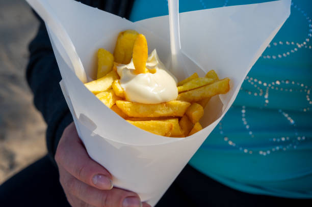 Street or take away food, fresh baked french fried potatoes chips in paper cone stock photo
