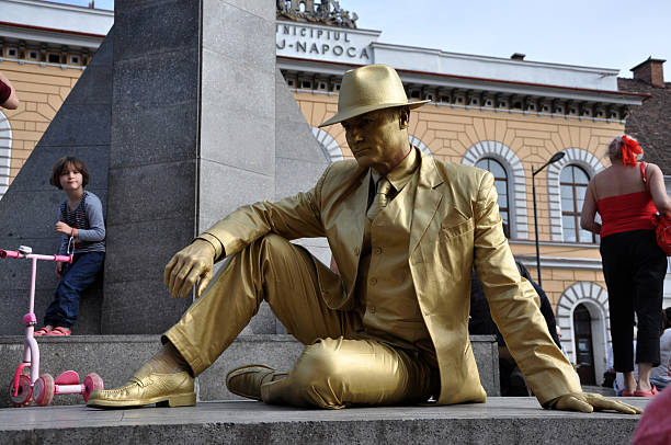 Street performer, living statue in golden costume stock photo