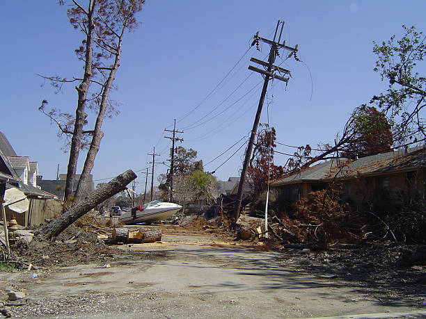 Street scene post-Katrina A boat is tossed onto a street in East New Orleans by Hurricane Katrina and flooding telephone pole photos stock pictures, royalty-free photos & images