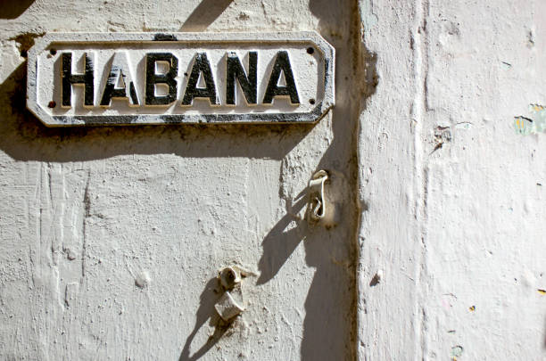 Street sign `Habana` in old Havana city in Cuba over a concrete white wall. stock photo
