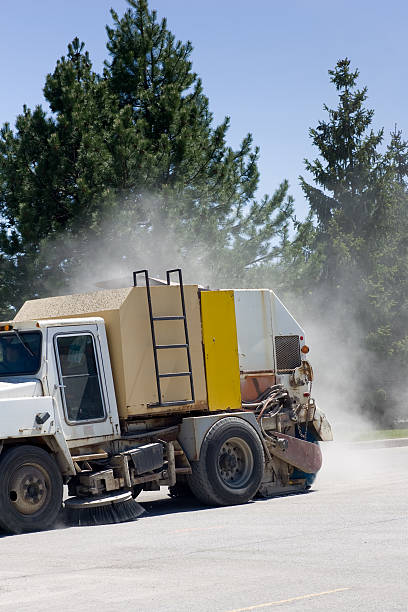 Street sweeper with dust trail stock photo
