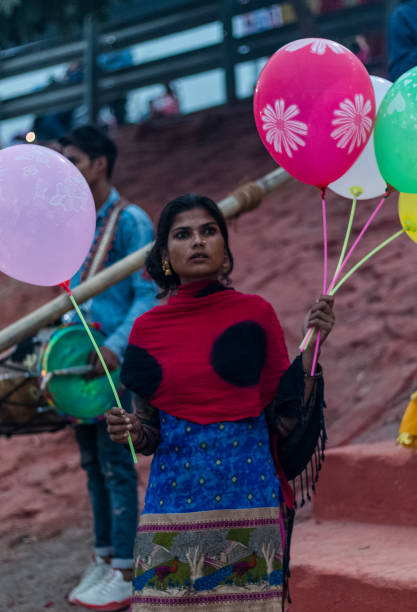 Street Vendor of balloon during Chhat Puja GHAZIABAD, UTTAR PRADESH/INDIA - NOVEMBER 2019 : Girls selling Balloons during the CHHATH Puja celebration at the river Bank of Hindon, Ghaziabad chhath stock pictures, royalty-free photos & images