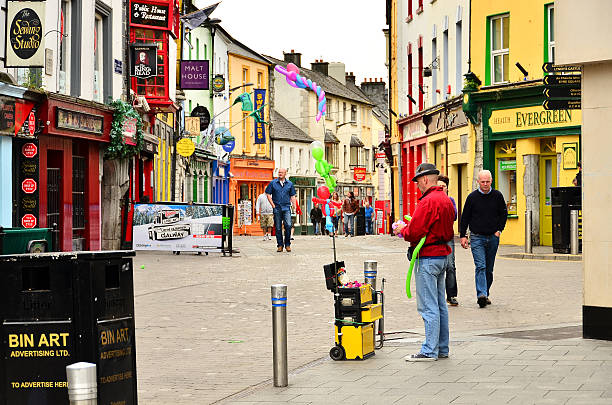 Street vendor of balloons in Galway, Ireland "Galway, Ireland - May 1, 2011: Man selling balloons in the main shopping area (&amp;quot;Latin Quarter&amp;quot;) in Galway. Along it you can find all kinds of shops, pubs and restaurants." galway stock pictures, royalty-free photos & images