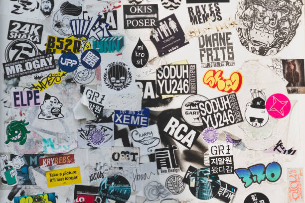: Street wall covered numerous multicolored stickers. stock photo