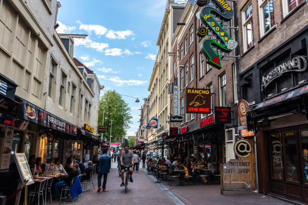 street with restaurants in amsterdam, netherlands - amsterdam street imagens e fotografias de stock