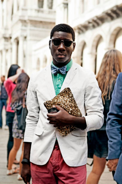 Streetstyle in Milan Fashion Week Milan, Italy -September 27th 2011: Elegant man walking in Piazza del duomo outside the runway booth. Last day of Fashion week in Milan lots of people well dressed were passing by wanting to be captured by a camera and probably like to be seen in fashion blogs. fashion week stock pictures, royalty-free photos & images