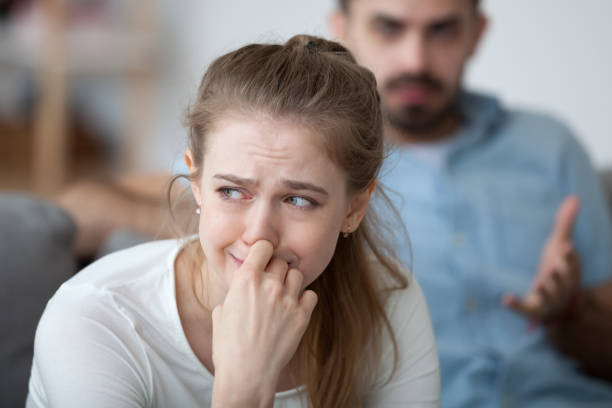 Stressed woman crying feeling depressed offended by controlling husband tyrant Stressed woman crying feeling depressed offended by controlling husband tyrant stock pictures, royalty-free photos & images
