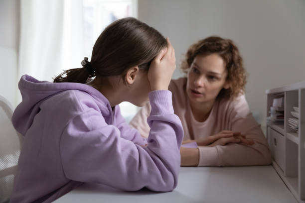 Strict angry mother scolding teenage daughter for bad exam results Strict mother scolding upset depressed teenage daughter for bad marks or school exam results, angry mum lecturing lazy unmotivated teen girl, generations, parent and child conflict punishment stock pictures, royalty-free photos & images