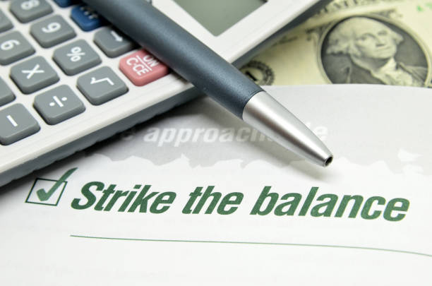 Strike the balance printed on book Strike the balance printed on book with calculator and pen rich strike stock pictures, royalty-free photos & images