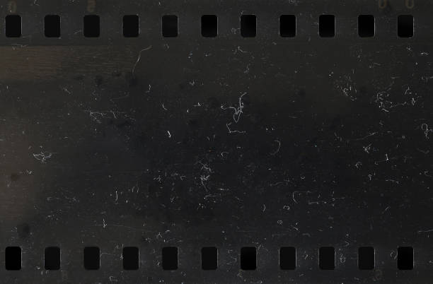 Strip of old celluloid film with dust and scratches stock photo