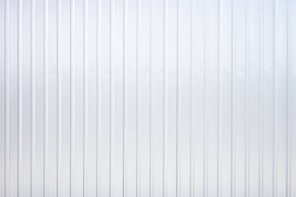 Striped wave silver steel metal sheet industry or construction site wall texture pattern for background. stock photo