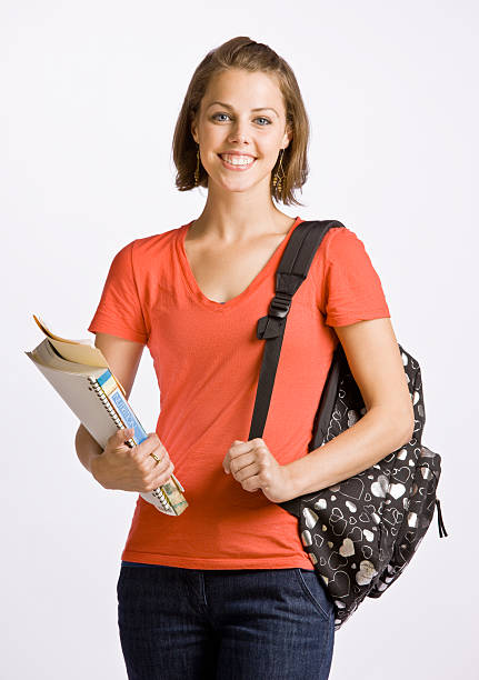Student Carrying Backpack and Books stock photo