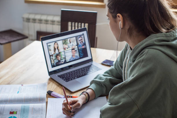 Student learning during isolation period Young women at home during pandemic isolation learning online education stock pictures, royalty-free photos & images