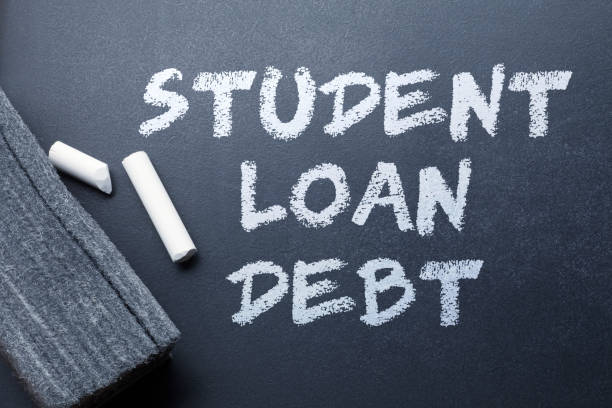 Student Loan Debt A chalk eraser and a broken piece of chalk rest on top of a black chalboard that has "Student Loan Debt" written on it. student loan forgiveness foreigh stock pictures, royalty-free photos & images