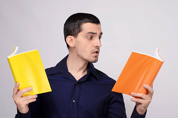 Student looking amazed at the books. Surprised teacher. stock photo
