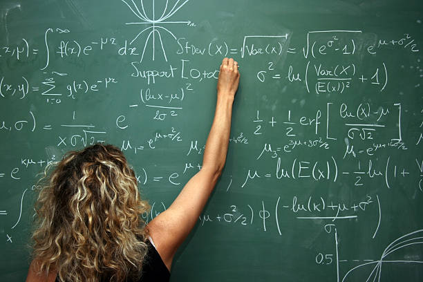 student solves mathematics problem on blackboard  quantum physics stock pictures, royalty-free photos & images