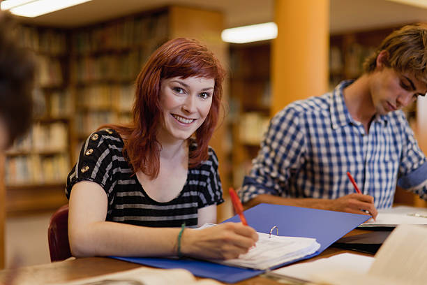 Students studying together in library