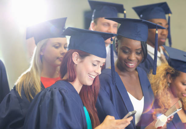 Students texting during graduation ceremony  best schools stock pictures, royalty-free photos & images