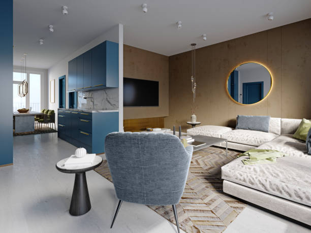 studio apartment with blue kitchen furniture and white with brown walls and a living room with a soft sofa and armchair and a tv area. - tv studio imagens e fotografias de stock