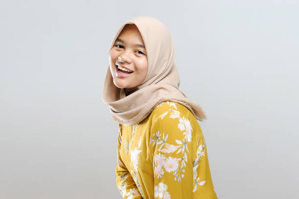 Studio Beauty Shoot. Young Beautiful Muslim Asian Woman on grey background Studio Beauty Shoot. Young Beautiful Muslim Asian Woman on grey background indonesian girl stock pictures, royalty-free photos & images