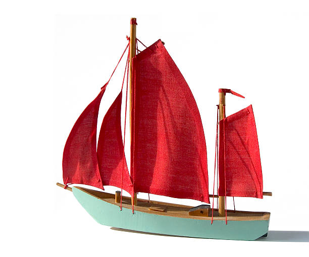 Studio Objects; Turquoise model sailing ship with red sails stock photo