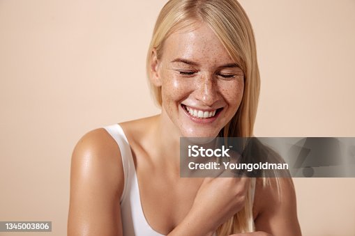 istock Studio shot of a happy caucasian woman adjusting her hair with closed eyes 1345003806