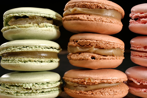 Close up shot of traditional assorted french dessert of fresh colorful macarons in a row