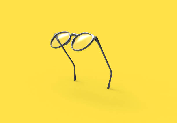 studioaufnahme mit fliegenden schwarzen gläsern auf gelbem hintergrund - brille stock-fotos und bilder