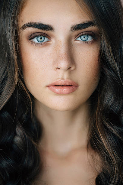 Studio shot of young beautiful woman Studio shot of young beautiful woman. Professional make-up and hairstyle.  blue eyes stock pictures, royalty-free photos & images