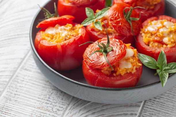 Stuffed baked Tomatoes with Rice and cheese. Selective focus, close-up. stock photo