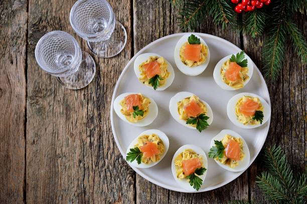 Stuffed chicken eggs with soft cheese, capers and salted salmon. stock photo