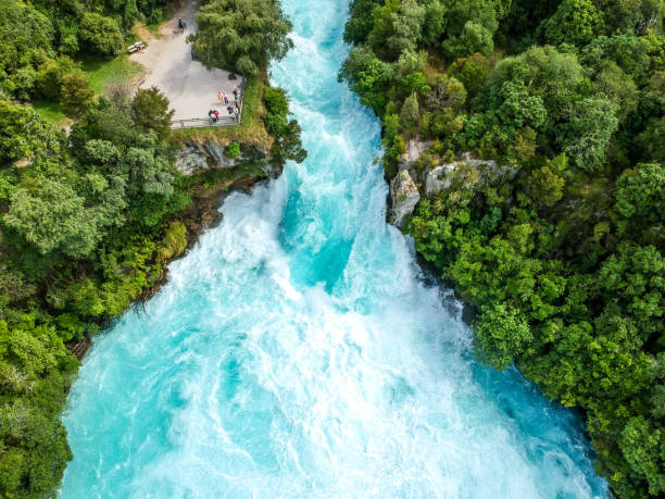 Stunning aerial wide angle drone view of Huka Falls waterfall in Wairakei near Lake Taupo in New Zealand. The waterfall is part of the Waikato River and is a major tourist attraction. stock photo