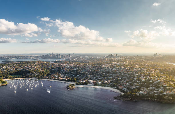 Stunning high angle aerial drone view of Balmoral Beach and Edwards Beach in the suburb of Mosman, Sydney, New South Wales, Australia. CBD, North Sydney and Chatswood in the background left to right. stock photo