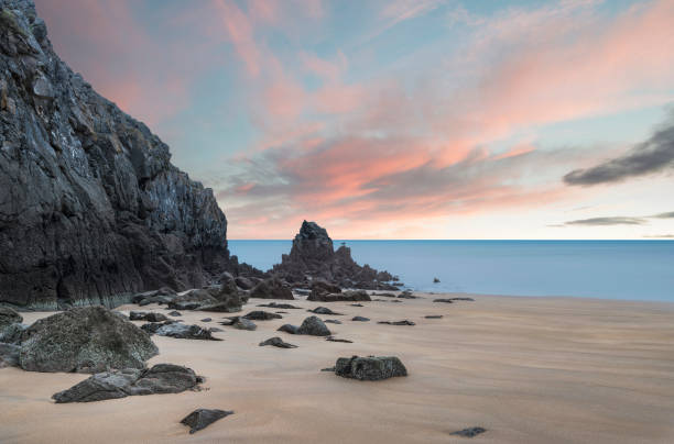 Stunning, vibrant sunrise landscape image of Barafundle Bay on Pembrokeshire Coast in Wales stock photo