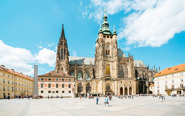 St.Vitus Cathedral in Prague castle Prague, Czech Republic - May 20, 2016: Prague castle. Lovely spring day. People walking near St.Vitus Cathedral - the largest and most important church in the Czech Republic.  hradcany castle stock pictures, royalty-free photos & images