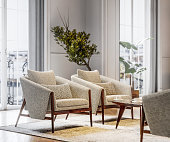 istock Stylish armchairs in brightly lit living room 1316508747