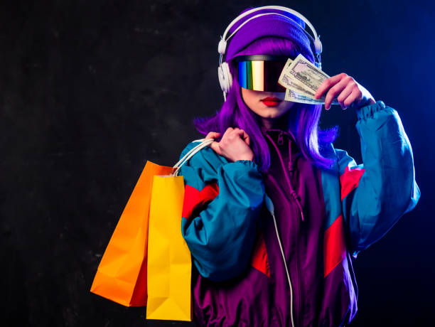 Stylish girl in cyber punk glasses and 80s tracksuit with shopping bags and money stock photo